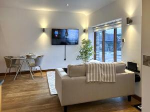 a living room with a couch and a table at Oak in Falmouth