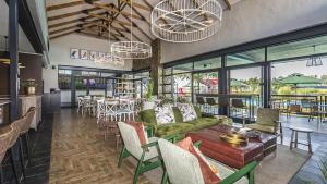 a restaurant with a table and chairs and windows at Lifestyle apartment in Sandton - Urban39 in Sandown
