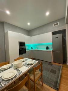 a kitchen with a table and chairs and a kitchen with a refrigerator at Casa Linda in Pavia