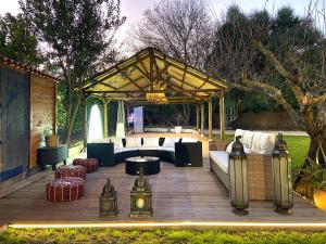 a wooden deck with a pavilion with couches and a table at FINCA ALMAZARA in San Pablo