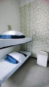 two bunk beds in a room with a wall at Hostel Castello Maggiore in Rome
