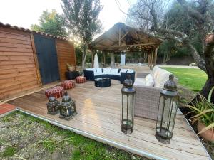 a wooden deck with a couch and lights on it at FINCA ALMAZARA in San Pablo