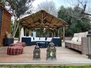 a wooden deck with a gazebo with a couch and tables at FINCA ALMAZARA in San Pablo +39 photos