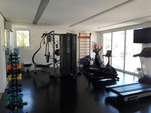 a room with a gym with machines and a treadmill at Beach Living, apart. duplex, o melhor da região. in Aquiraz