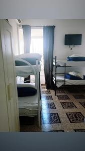 a room with two bunk beds and a window at Hostel Castello Maggiore in Rome +21 photos