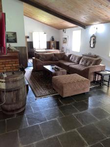 a living room with a couch and a barrel at Fazenda Kidauana - Mendes in Mendes