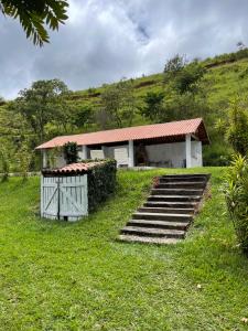 a house with a gate and stairs in front of it at Fazenda Kidauana - Mendes in Mendes