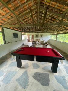 a pool table in the middle of a room at Fazenda Kidauana - Mendes in Mendes