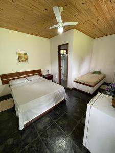 a bedroom with two beds and a ceiling fan at Fazenda Kidauana - Mendes in Mendes