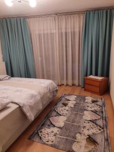 a bedroom with a bed and a rug at Maria's House in Thessaloniki