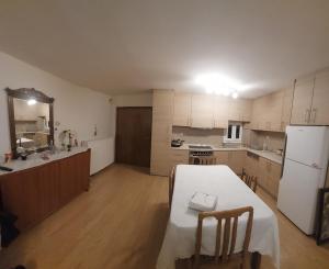 a kitchen with a table and a white refrigerator at Maria's House in Thessaloniki