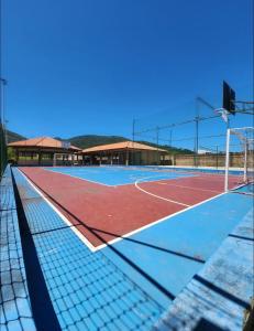 a tennis court with a net on top of it at Condomínio Vista Atlântico - Apartamento Novo - Próximo à Praia - Vista Mar - Área de Lazer in Itapema