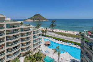 a view of the beach from the balcony of a resort at Apart hotel a Beira Mar na praia do Recreio in Rio de Janeiro