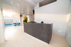 a lobby with a reception desk in a building at Hotel Santa Marta Tropical in Santa Marta