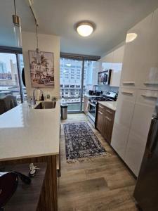 a kitchen with white appliances and a large window at NVCLL Chicago in Chicago