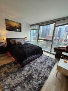 a bedroom with a large bed and a large window at NVCLL Chicago in Chicago