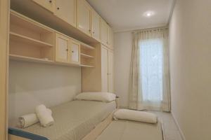 ein kleines Zimmer mit 2 Betten und einem Fenster in der Unterkunft 004 - Club Náutico 001 - comfortHOLIDAYS in Santa Pola