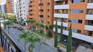 a city street with palm trees and a building at Laureles 401 in Medellín