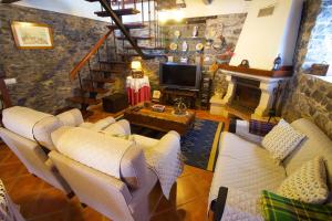 a living room with couches and a fireplace at Casa da Rainha in Calheta
