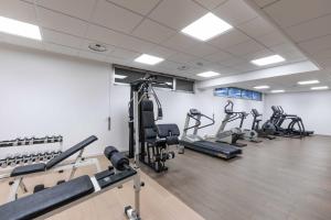 a gym with rows of treadmills and machines at Belstay Venezia Mestre in Marghera