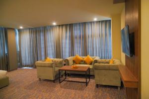 a living room with two couches and a table at Destination Hotel Gilgit in Gilgit