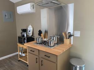 a kitchen with pots and pans on a counter at Louisiana State Cabin in West Point