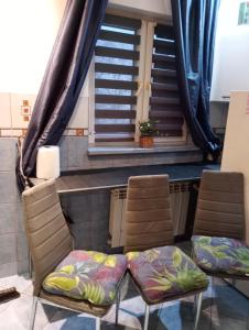two chairs and a table in a room with stairs at Apartamenty na doby in Siedlce