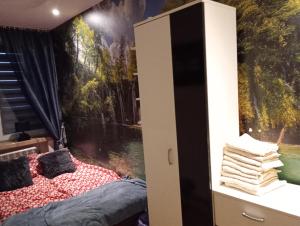 a bedroom with a bed and a wall mural at Apartamenty na doby in Siedlce