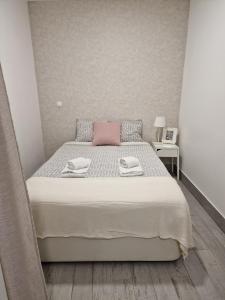 a bedroom with a large bed with a pink pillow at Alfama - Close to Everything in Lisbon