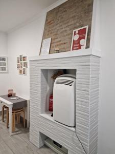 a microwave in a gray brick fireplace with a table at Alfama - Close to Everything in Lisbon