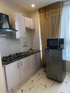 a kitchen with a sink and a microwave at Luxe Suites Bahria Town Lahore in Lahore