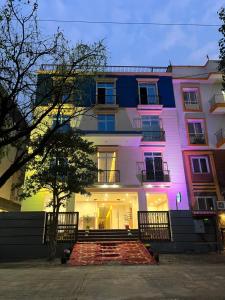 a building with colorful lights on the side of it at The Blue Vista in Greater Noida