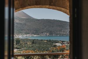 a view of a lake from a window at Brazzo di Maina in Oitylo