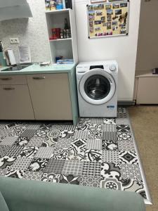 a laundry room with a washing machine and a counter at Centrum Apartmán Armida in Bardejov