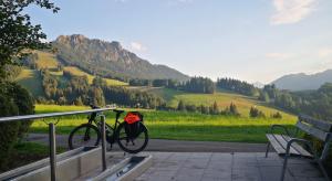 a bike parked next to a bench with a backpack at Jungholz Erlebnis in Jungholz