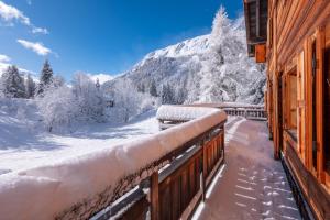 a snow covered balcony with a view of a mountain at Spacious family chalet with balcony and garden in Chamonix
