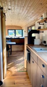 a kitchen with a sink and a table in a room at VAGONBublava in Bublava