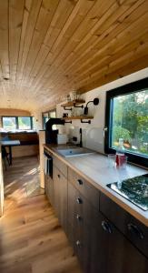 a kitchen with a large window in a tiny house at VAGONBublava in Bublava