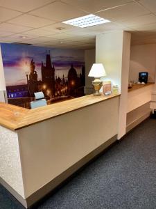 an office cubicle with a large picture of a city at Hotel Oáza Praha in Prague