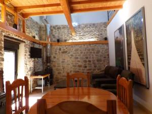 a living room with a table and a couch at El Bierzo Oro en el Camino in Villaverde de la Abadía +23 photos