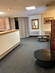 a waiting room with a counter and a table at Hotel Oáza Praha in Prague