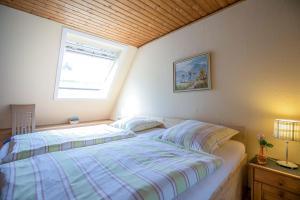 a bedroom with a bed and a window in it at Ferienhaus an der Baeke D in Bad Zwischenahn