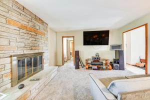 a living room with a fireplace and a tv at Convenient Racine Home 4 Mi to Lake Michigan! in Racine