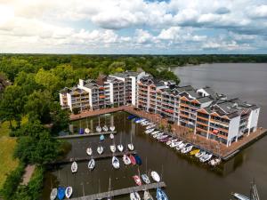 an aerial view of a resort with boats in a marina at Yachthafen am Delf in Bad Zwischenahn