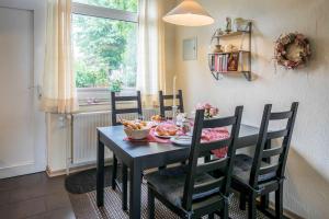 a black dining room table with a bowl of food on it at Ferienhaus an der Baeke A in Bad Zwischenahn