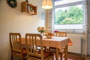 a dining room table with a bowl of fruit on it at Ferienhaus an der Baeke E in Bad Zwischenahn +10 photos