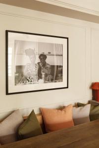 a black and white picture of a man on a wall at luxury apartment saint germain des près Paris in Paris