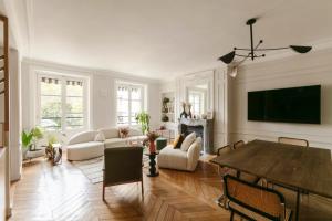 a living room with a table and a tv at luxury apartment saint germain des près Paris in Paris