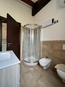 a bathroom with a shower and a toilet and a sink at Casa Ziretto in Castelmola