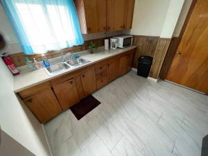 a kitchen with two sinks and a microwave at 3 Bed House in Niagara Falls in Niagara Falls